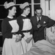 Two nurses attend a young hospital patient in this 1952 photo.